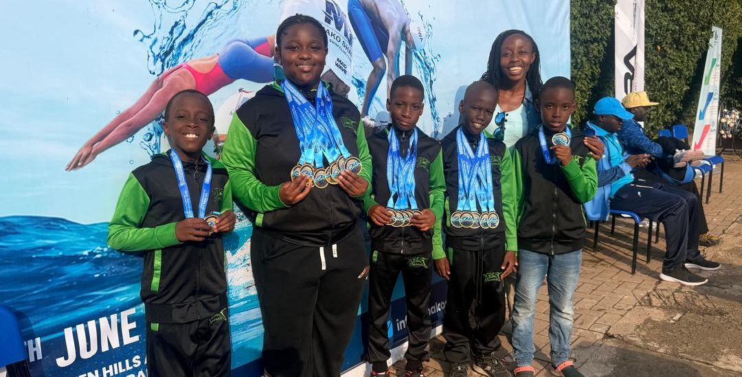 Jaguar Swim Club young swimmers posing with medals at the 5th Mako Sharks Championships in Kigali Rwanda.