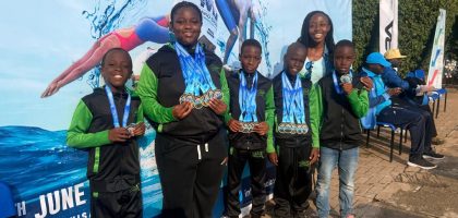 Jaguar Swim Club young swimmers posing with medals at the 5th Mako Sharks Championships in Kigali Rwanda.