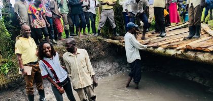 Smiling together after a job well done. This photo captures a moment of shared pride between community members and leadership, celebrating the dedication of the local men who collaborated on restoring the area's essential water source.